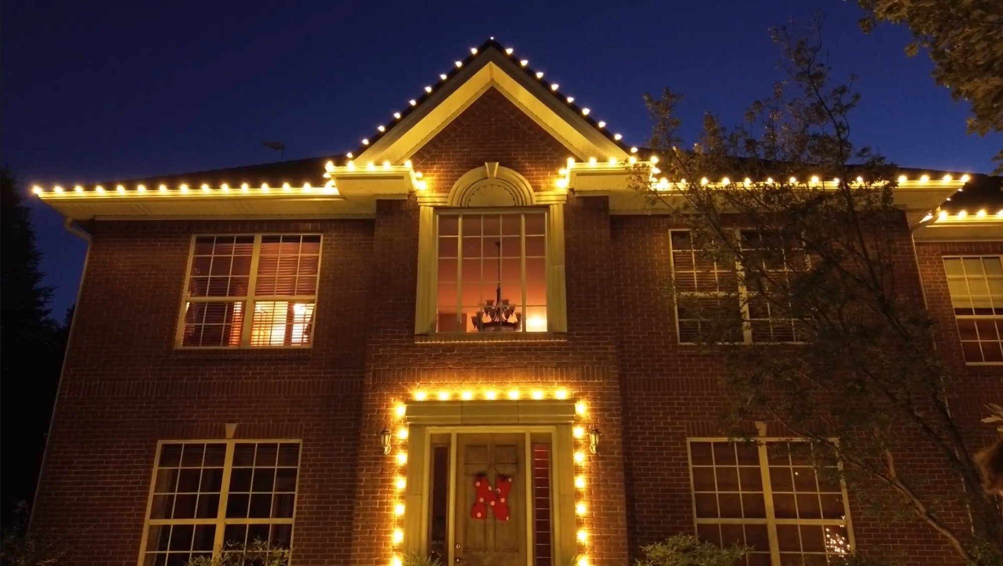 Warm white on every gable line and the front entry
