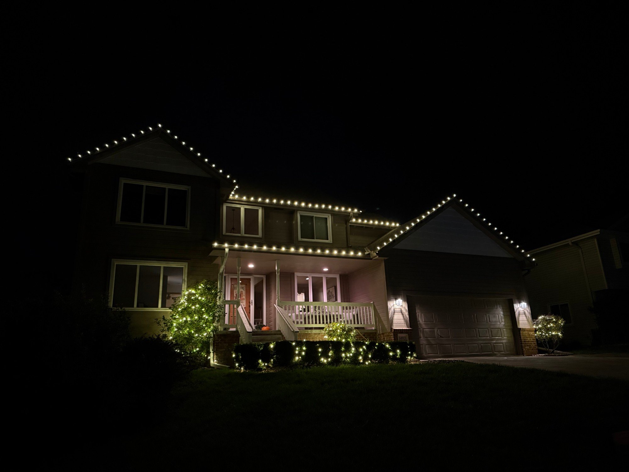 Full roofline with wrapped shrubs and accent trees