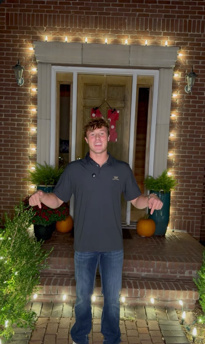 Crown Lighting owner at a front entry he lit